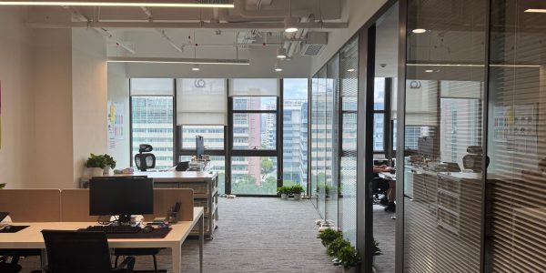 Bright, modern office interior with large windows and open workspace design.